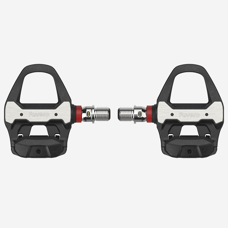 Pair of black and silver bicycle pedals on a light gray background