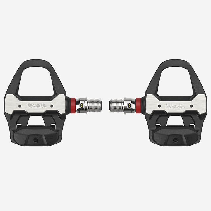 Pair of black and silver bicycle pedals on a light gray background
