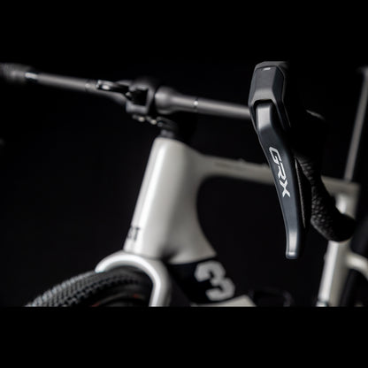3T Racemax Italia size 54 in Pearl White, equipped with 50mm DT Swiss GRC 1400 wheels and Shimano GRX Di2 12-speed electronic drivetrain, photographed against a sleek black background.