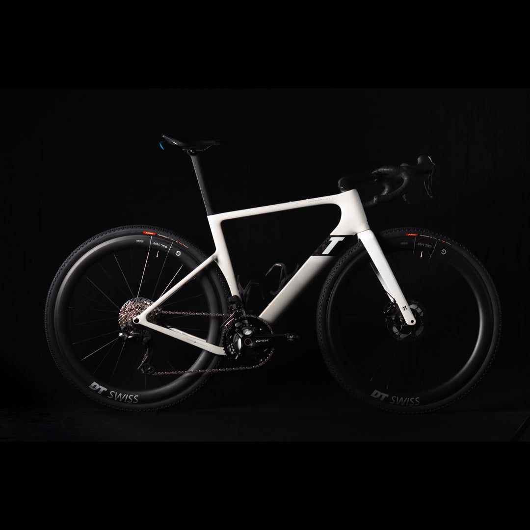 3T Racemax Italia size 54 in Pearl White, equipped with 50mm DT Swiss GRC 1400 wheels and Shimano GRX Di2 12-speed electronic drivetrain, photographed against a sleek black background.