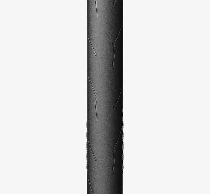 Close-up front of a Black Pirelli PZero Race tire with detailed tread pattern on a white background - Dragonspine Cycling
