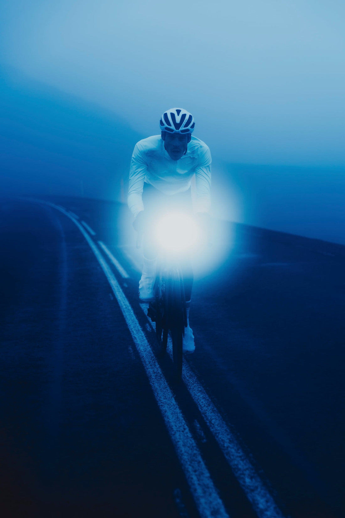 Rider on a misty road with a headlight