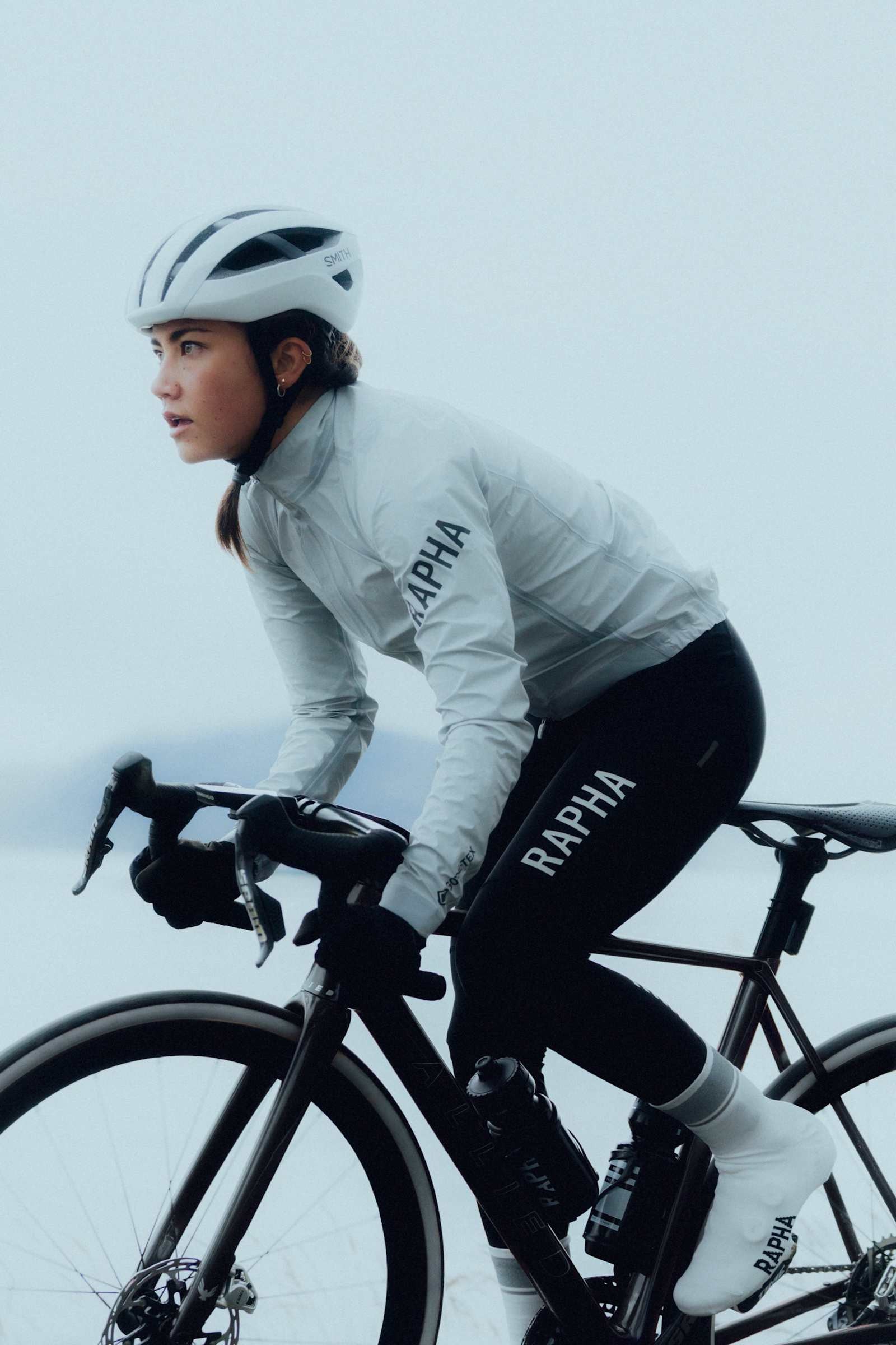 Rider in a Rapha Pro Team Shadow jacket on a misty road