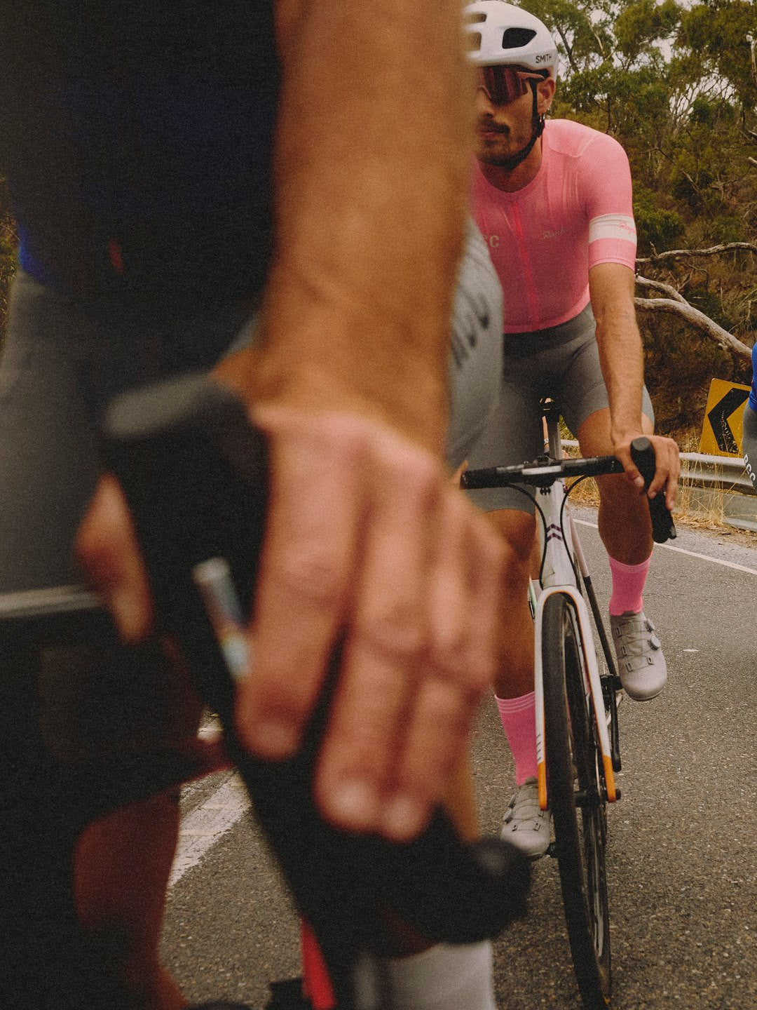 Rider in a pink Rapha jersey on a road bike